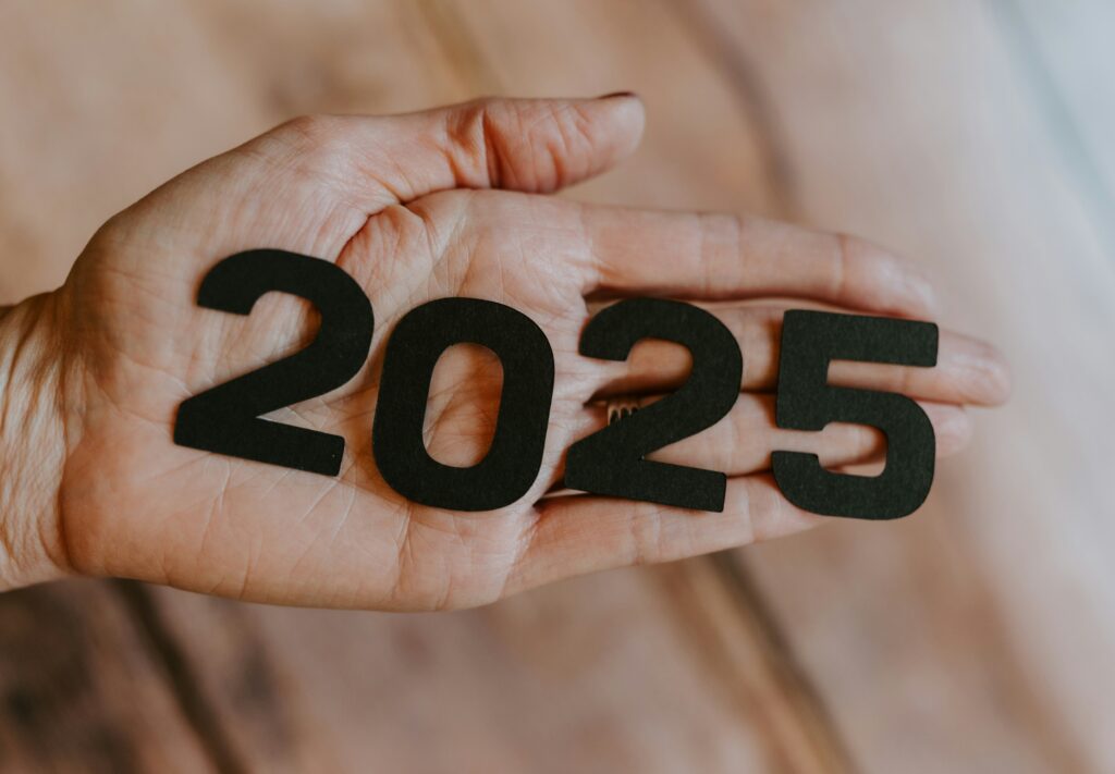 Picture of a hand holding the number 2025 representing the new year.