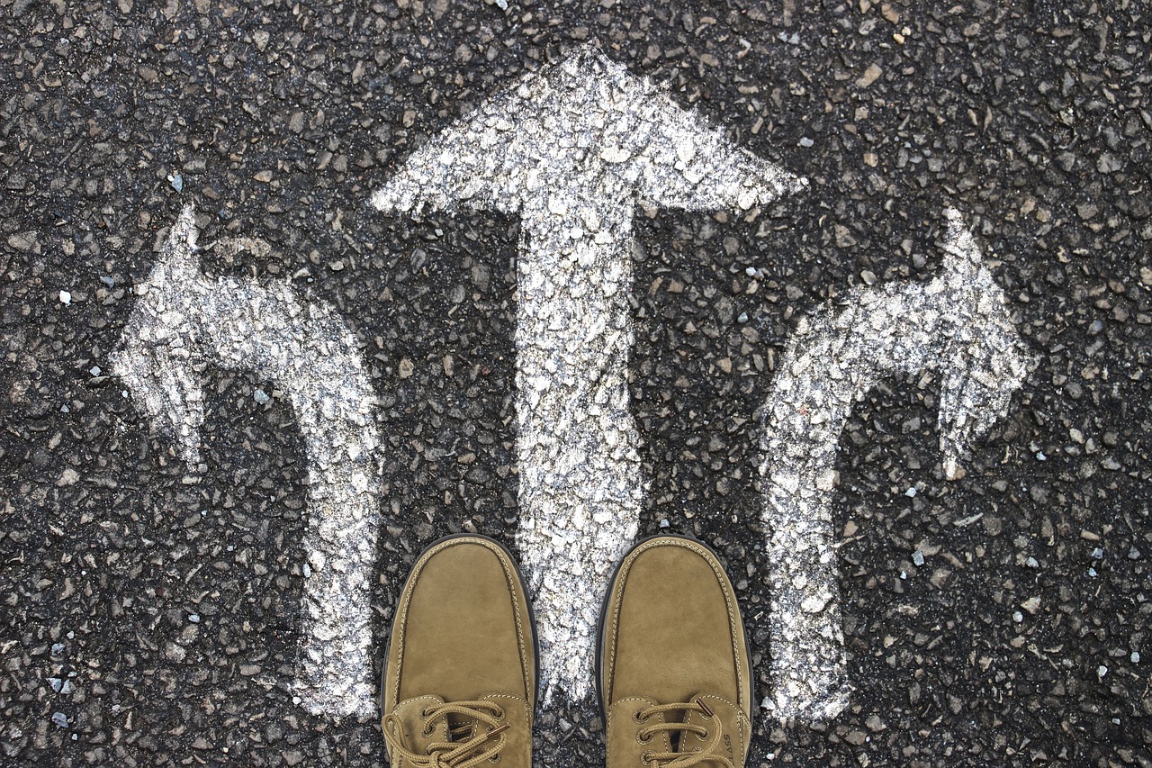 Image showing a person looking down at their feet with multiple paths to choose from to move forward.